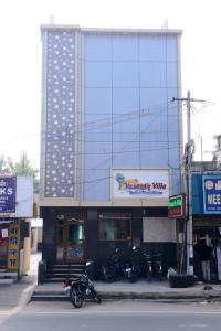 a building with motorcycles parked in front of it at Vasanth Villa in Kanchipuram