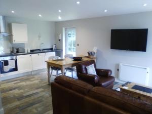 a living room with a couch and a table at Waterside Cottage in York