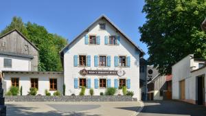 a white building with a sign on the front of it at Schade's Wohlfühlhotel in Selb