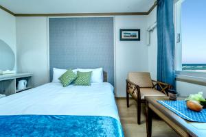 A bed or beds in a room at Beach Story Hotel