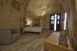 a large room with a bed and a couch at B&B Al Convento in Matera