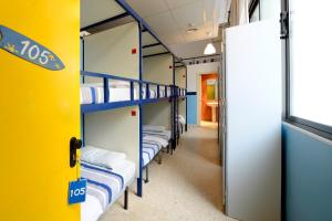 a row of bunk beds in a room at Sea Hostel Barcelona in Barcelona