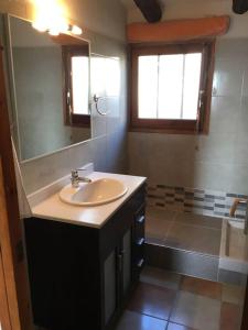 a bathroom with a sink and a mirror at L'ALMADRAVA OSTRAS 6 in L'Ametlla de Mar