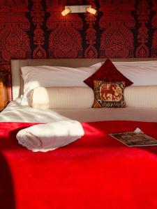 a bedroom with a bed with a red blanket at The Gallery in Port Isaac