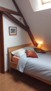 una camera da letto con un letto con cuscini sopra di Gîte la Chamoussière a Saint-Mury-Monteymond