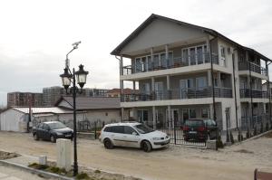 a large house with cars parked in front of it at California Dreaming in Mamaia Sat/Năvodari