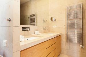 a bathroom with a sink and a mirror at Click&Flat Luxury Sant Joan in Barcelona