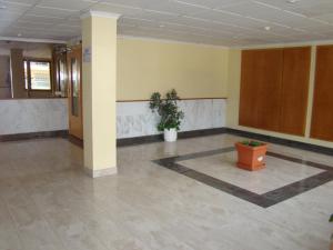 an empty room with a pillar and a potted plant at Apartamento Cap de Salou in Salou +24 photos