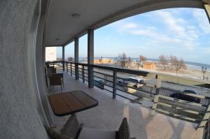 a balcony with a table and a view of the beach at California Dreaming in Mamaia Sat/Năvodari +13 photos