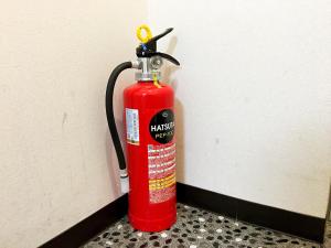 a red fire hydrant is attached to a wall at Osaka Tengachaya Guesthouse SAYURI II in Osaka