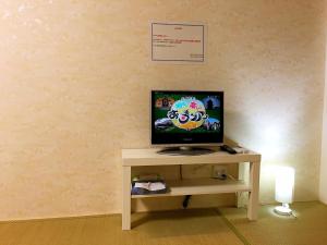 a television sitting on a table in a room at Osaka Tengachaya Guesthouse SAYURI II in Osaka