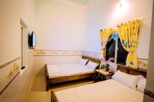 a room with two beds and a window at Motel Thuyền & Biển in Ly Son