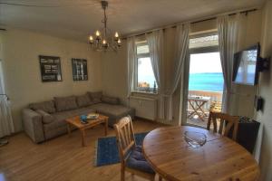 a living room with a couch and a table at Fuerstenhof Appartement 401 in Sassnitz