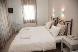 Postel nebo postele na pokoji v ubytování Pelican Hotel
