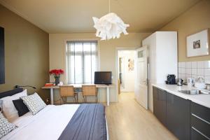 a bedroom with a bed and a kitchen with a sink at Canal Studio Apartment in Amsterdam