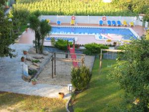 a backyard with a swimming pool with a slide at Hotel Cabo Festiñanza in Sanxenxo