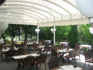 a restaurant with tables and chairs under a white canopy at Mediterran in Hamburg