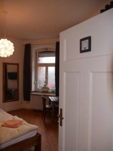 a bedroom with a bed and a window and a door at Alte Schmiede in Ascheberg