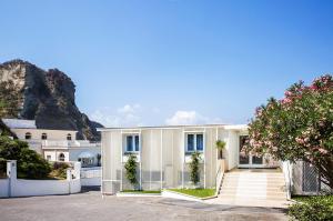 a house with a mountain in the background at Villa Aragonese Rooms in Monte di Procida