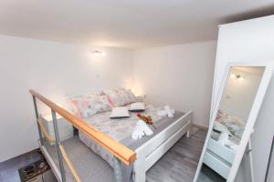 a small bedroom with a bunk bed with a mirror at Studio Apartment Vasilj in Split