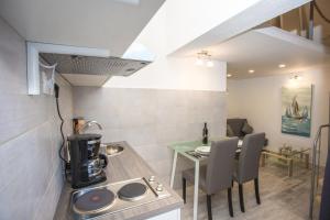 a kitchen and dining room with a table and a stove at Studio Apartment Vasilj in Split +18 photos