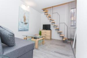 a living room with a staircase and a couch at Studio Apartment Vasilj in Split