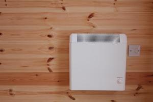 a white electrical box on a wooden floor at Howe of Torbeg in Ballater