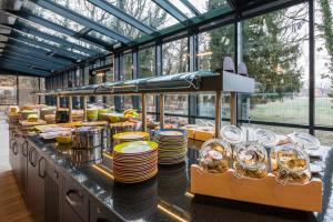 a buffet with plates and dishes on a counter at Hostel Art & Style in Singen