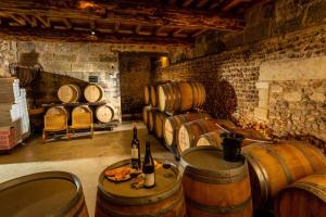 a room with a bunch of wine barrels at Mas du Notaire in Gallician