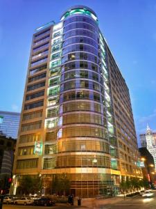 a tall building with glass windows on a city street at Kinzie Hotel in Chicago