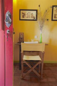 a room with a table and a chair and a sink at Monte da Xica - Somente Adultos in Zambujeira do Mar