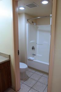 a bathroom with a white toilet and a shower at Gateway Studio Suites in Sierra Vista