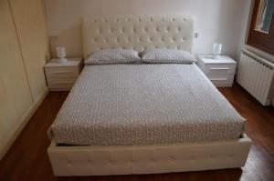 um quarto com uma grande cama branca com duas mesas de cabeceira em Lovely Apartment In Venice em Veneza