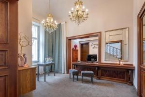a dressing room with a vanity and a mirror at Boutique Hotel Klarov in Prague