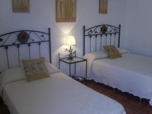 Postel nebo postele na pokoji v ubytování Hostal El Canario
