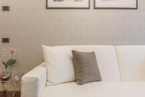 a white couch with a gray pillow on it at Ca' Del Monastero 8 Collection Apartment for 3 Guests in Venice
