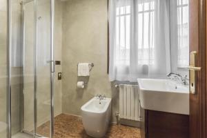 a bathroom with a sink and a toilet and a shower at Ca' Del Monastero 8 Collection Apartment for 3 Guests in Venice