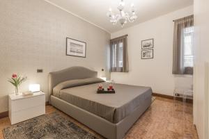 a bedroom with a large bed and a chandelier at Ca' Del Monastero 8 Collection Apartment for 3 Guests in Venice