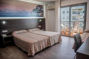 Postel nebo postele na pokoji v ubytování Hotel Prado II