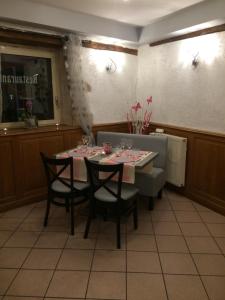 a dining room with a table and some chairs and a table and chairsktop at Sarl Macarena in Pouillenay