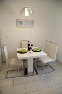 a white table topped with a white table cloth at Apartments Viskovic Margita in Hvar
