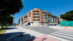 a large apartment building on a city street at Ático Olimpo in Torre del Mar