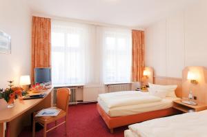 Postel nebo postele na pokoji v ubytování Hotel Benn