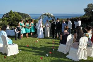 a bride and groom are standing under an outdoor ceremony at Mando Beachfront in Stafylos