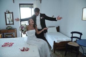 a bride and groom are dancing in a room at Mando Beachfront in Stafylos