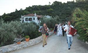 a group of people walking down a stone path at Mando Beachfront in Stafylos