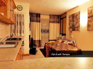 a kitchen with a table and a dining room at Pretty Bay Apartments in Birżebbuġa