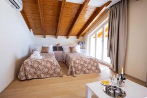una camera da letto con due letti e un tavolo di Ossuccio Grande C home with pool sleeps 12 by Italian Apartments a Como
