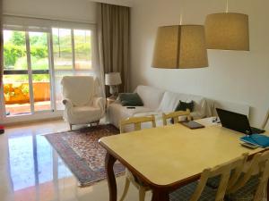a living room with a table and a couch at Madre Mia Apartment in Casares