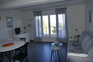 a living room with a couch and a table at Villa Heliomar in Cavalaire-sur-Mer